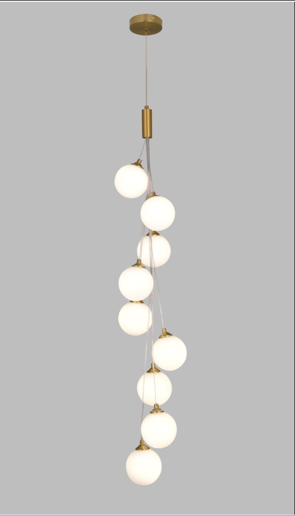 Modern pendant light with multiple round bulbs on a gray background