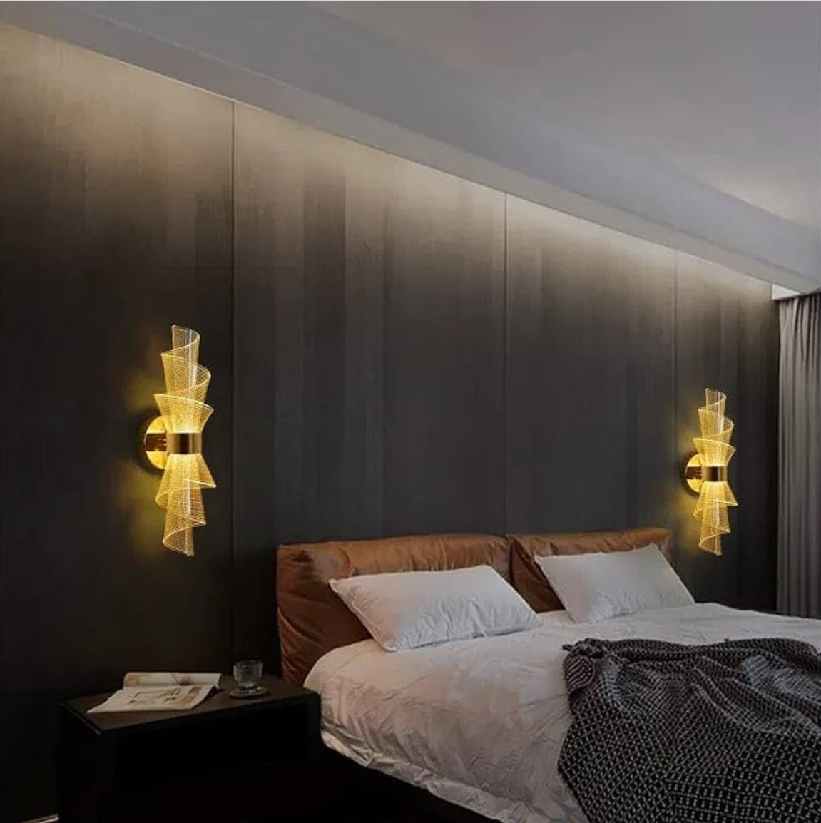 Modern bedroom with a bed, nightstands, and wall sconces.