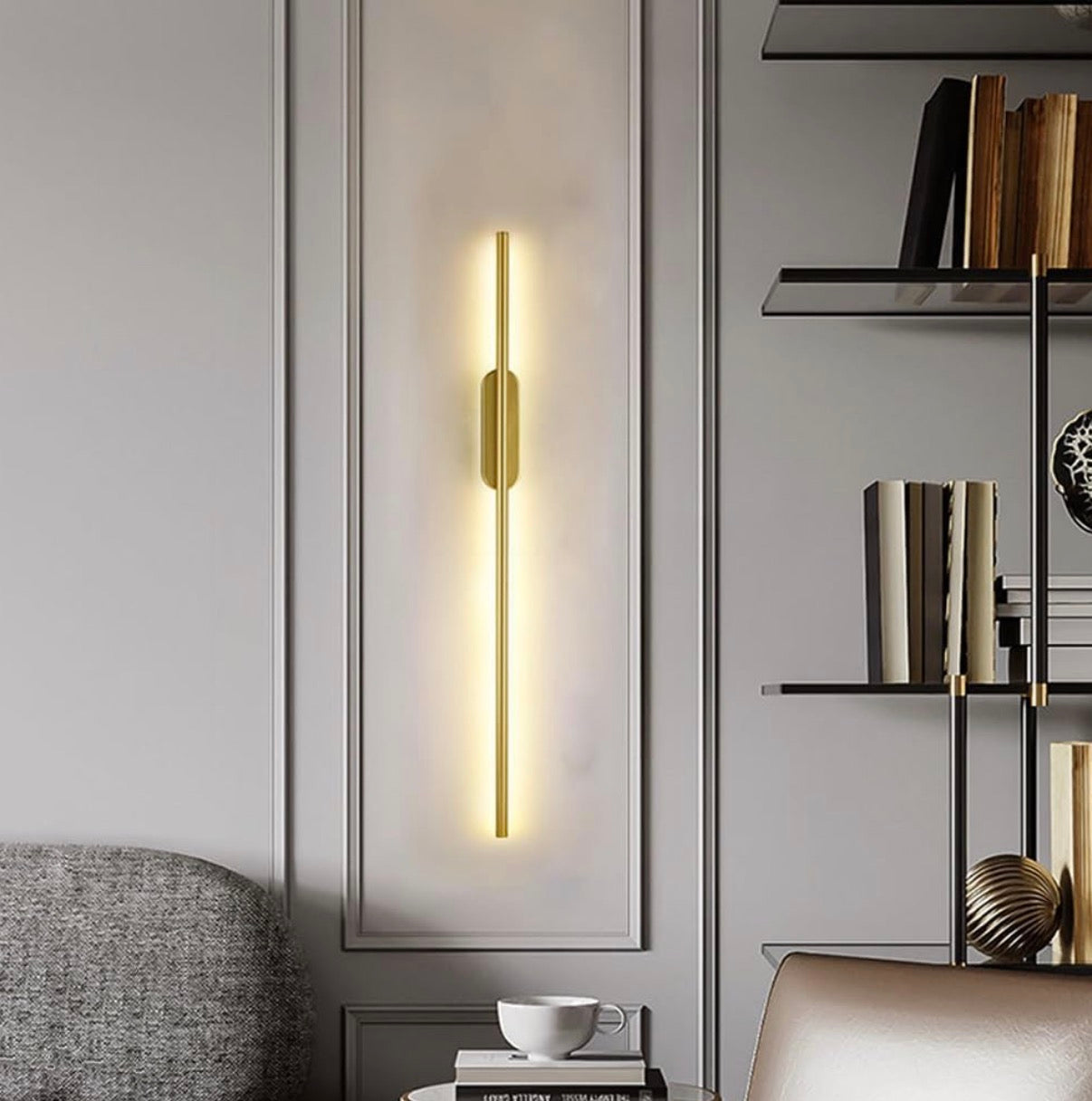 Modern wall sconce in a stylish interior setting with books and decor.