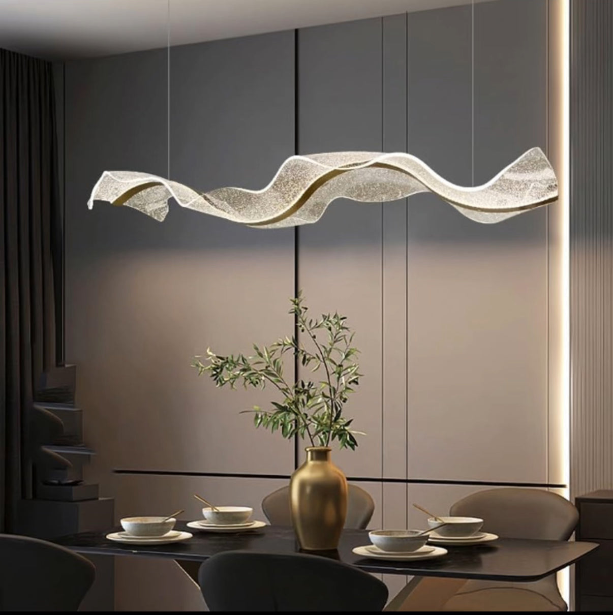 Modern dining room with a wavy pendant light fixture.