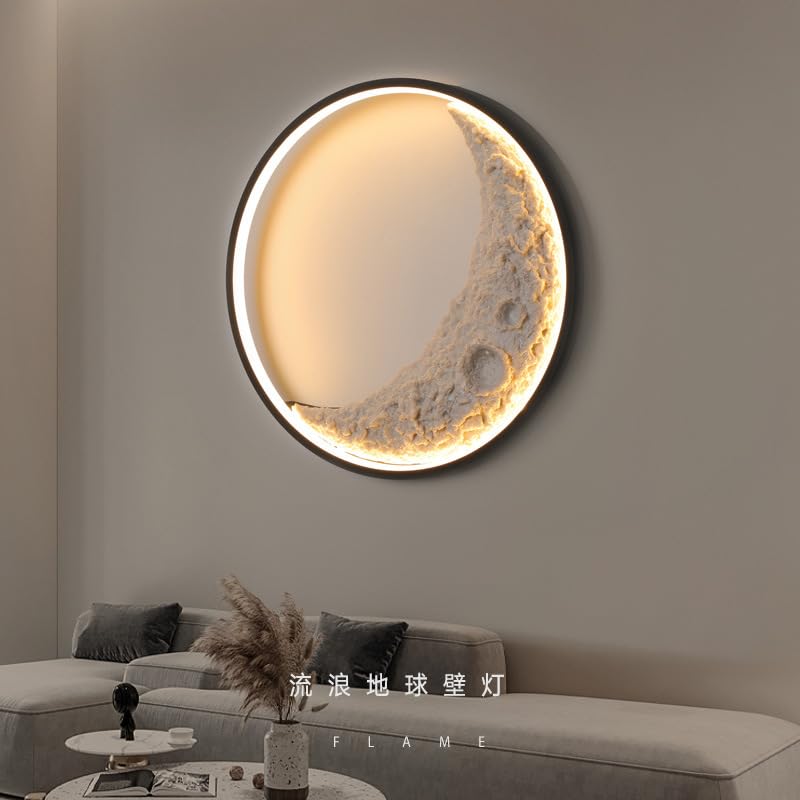Round wall lamp with moon design on a gray wall above a sofa