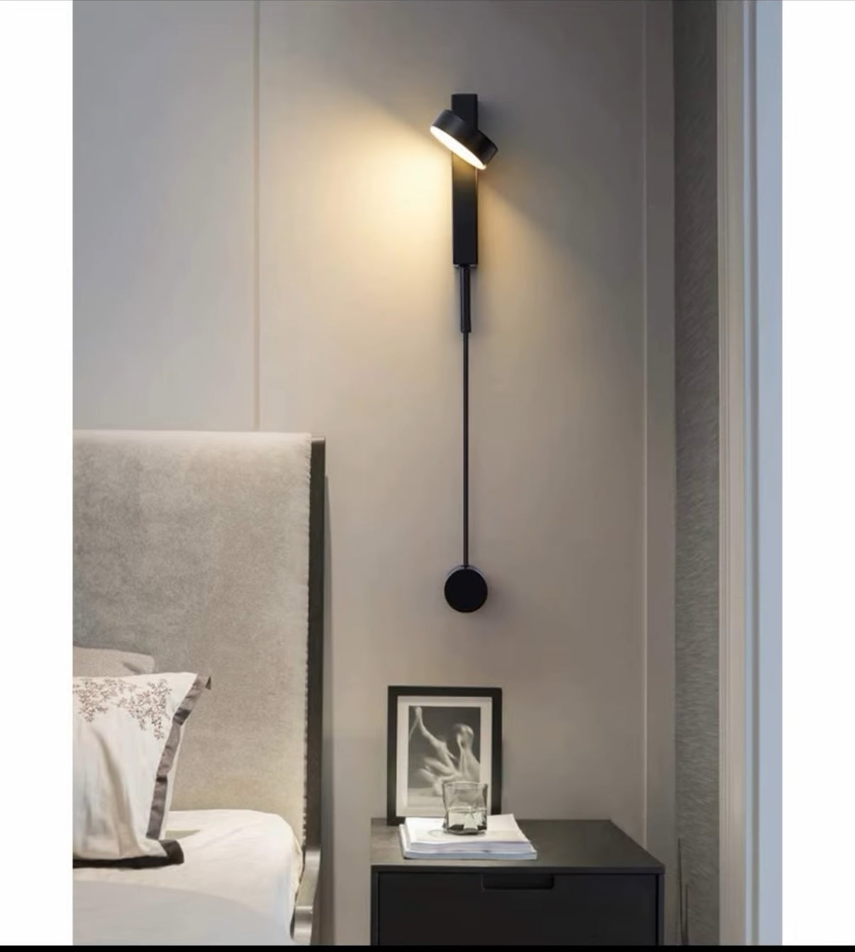 Modern wall lamp on a gray wall in a bedroom setting