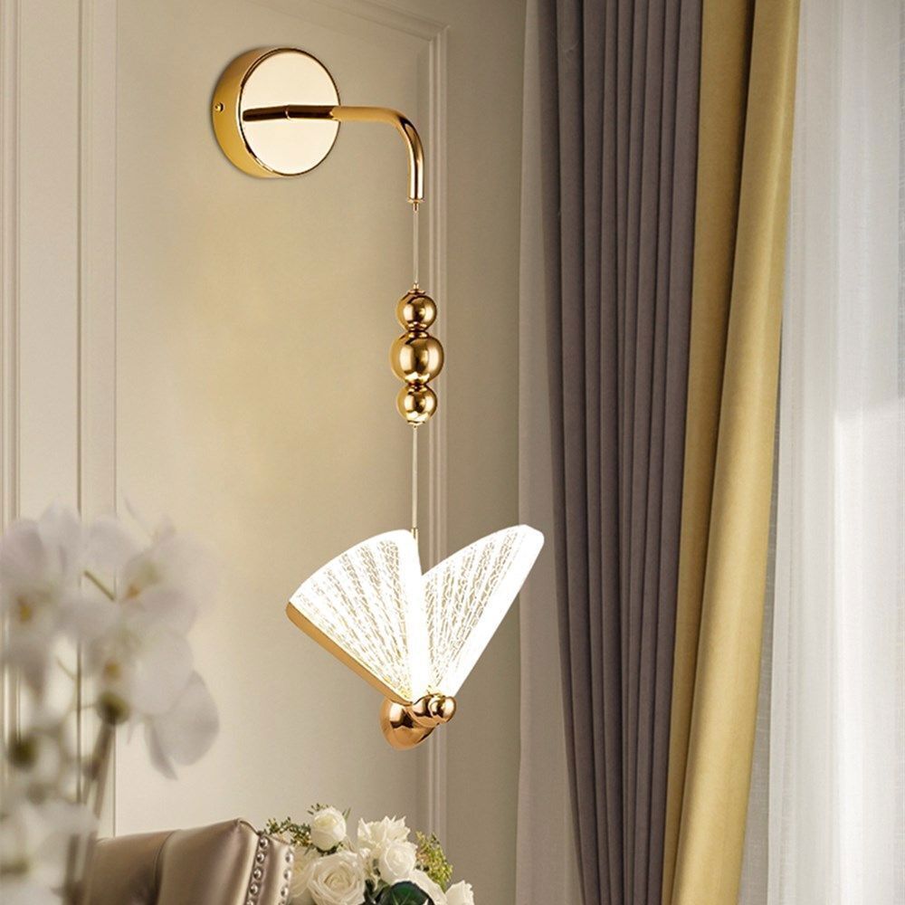 Decorative wall light fixture with gold accents in a room setting.