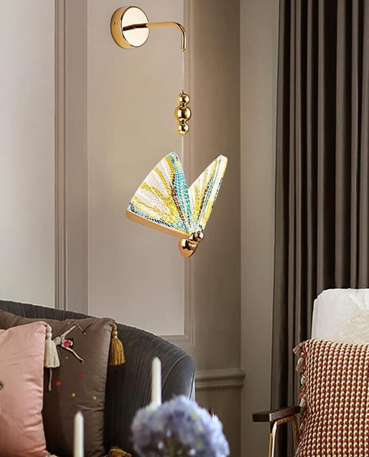 Decorative wall light fixture with colorful design in a living room setting.