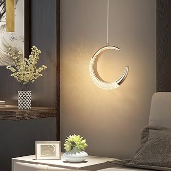Moon-shaped pendant light in a cozy room setting with decor elements.