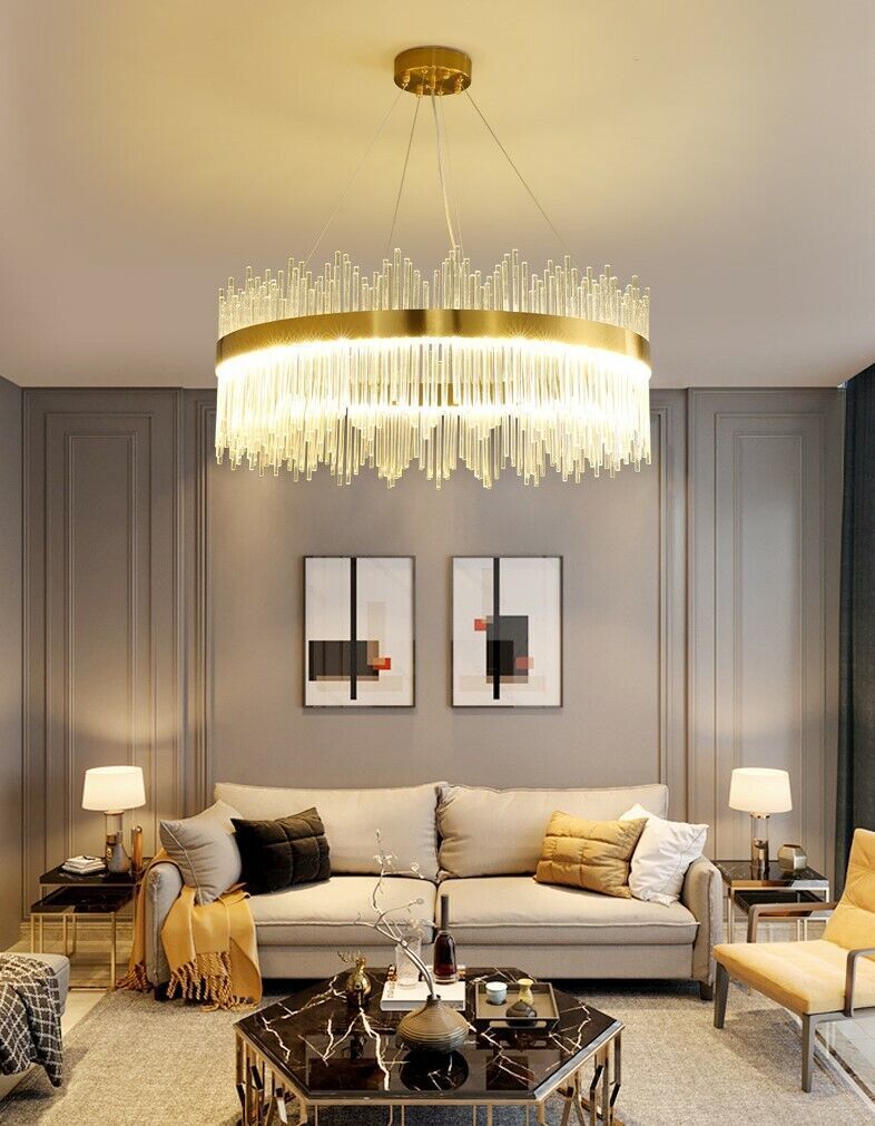 Modern living room with a chandelier, sofa, and coffee table.