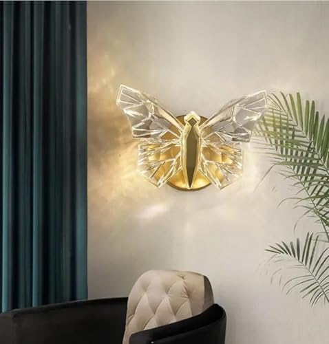 Butterfly-shaped wall light fixture on a wall with decorative elements.