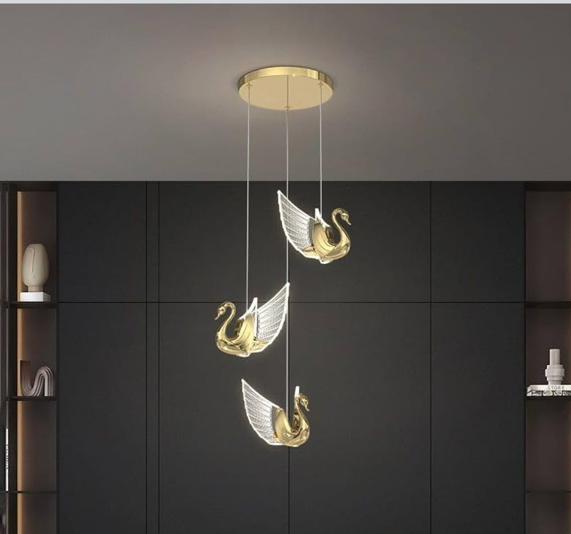 Ceiling light fixture with swan design against a dark wall