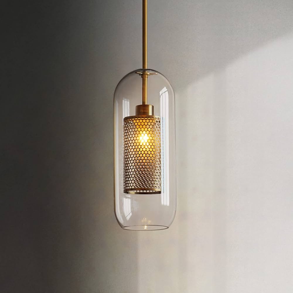 Pendant light with glass shade and metallic fixture on a neutral background
