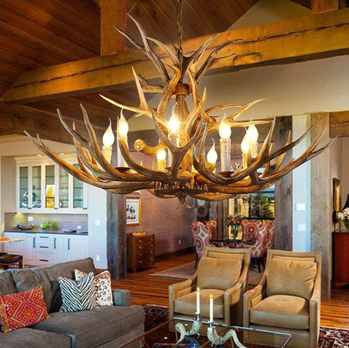 Antler chandelier hanging in a living room with wooden beams and furniture.
