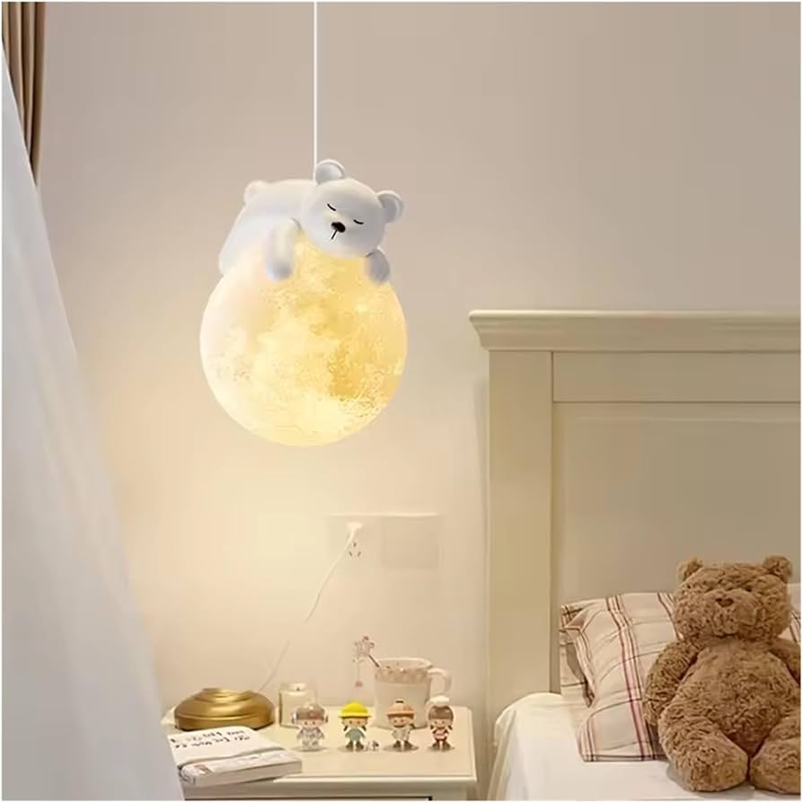 Children's room with a teddy bear-shaped pendant light and teddy bear on a bed.