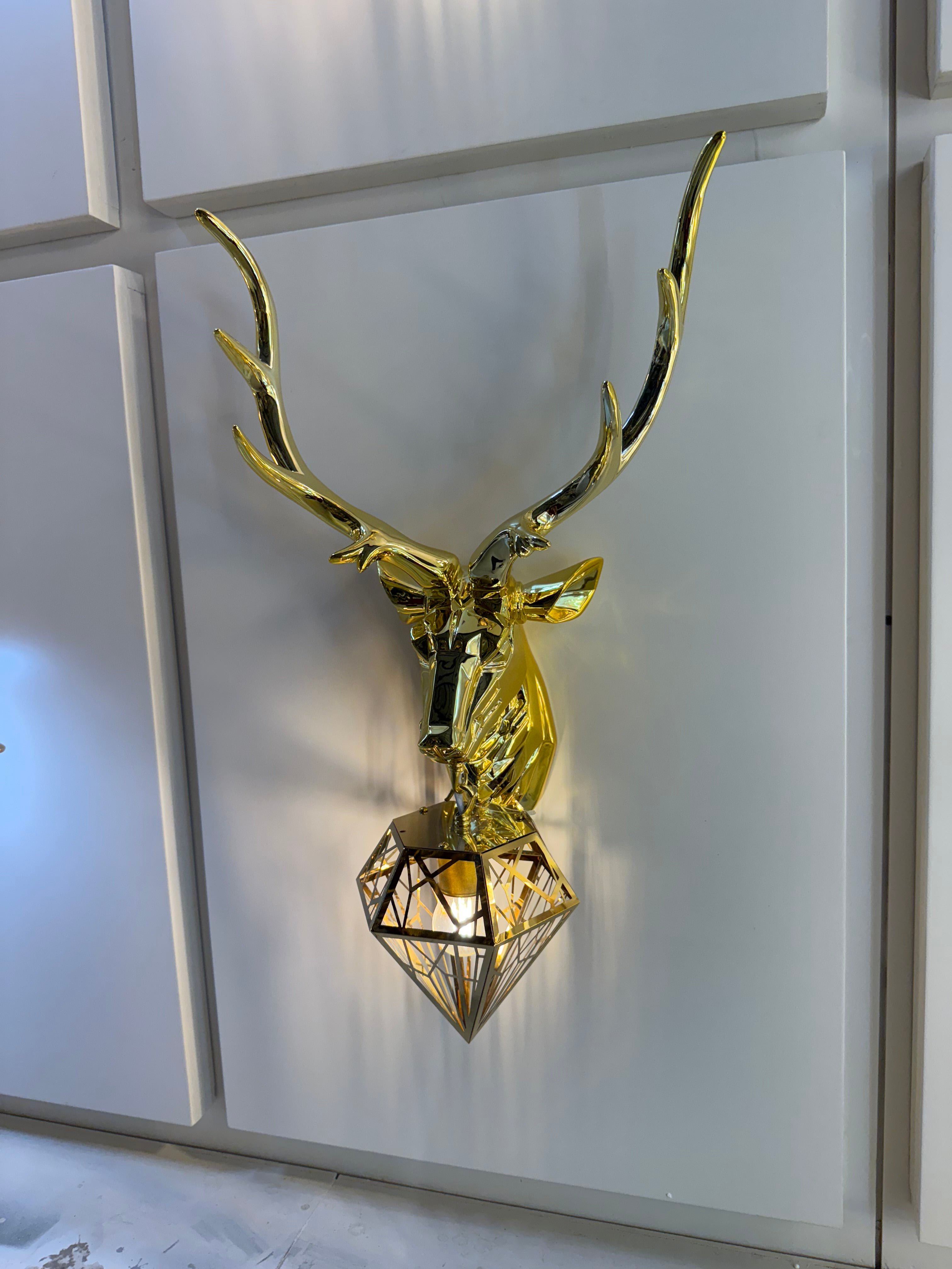 Gold wall sconce on a white wall