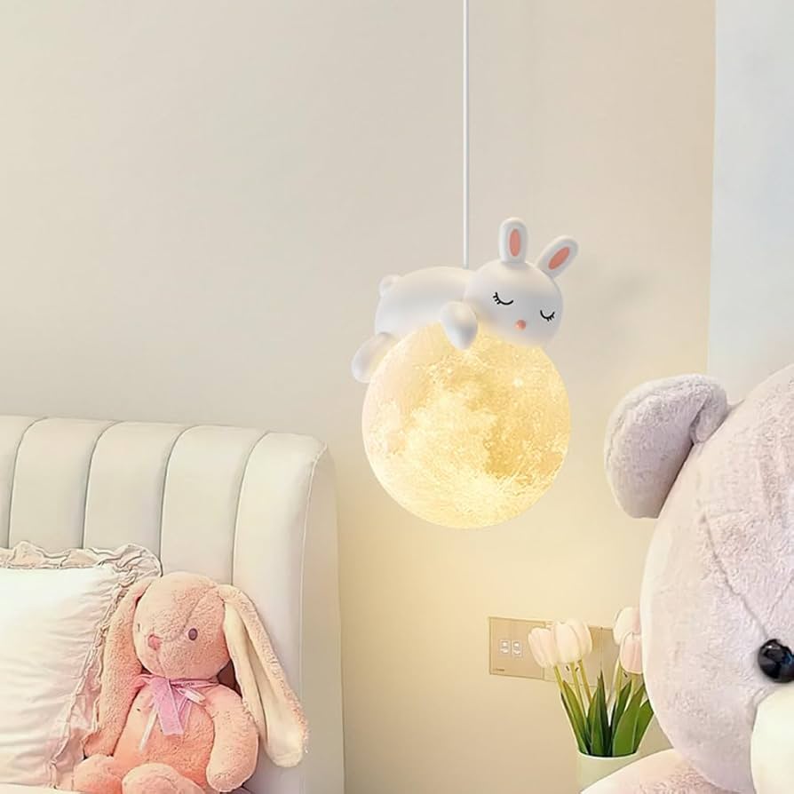 Children's room with a rabbit-shaped night light, teddy bear, and pink bunny toy.
