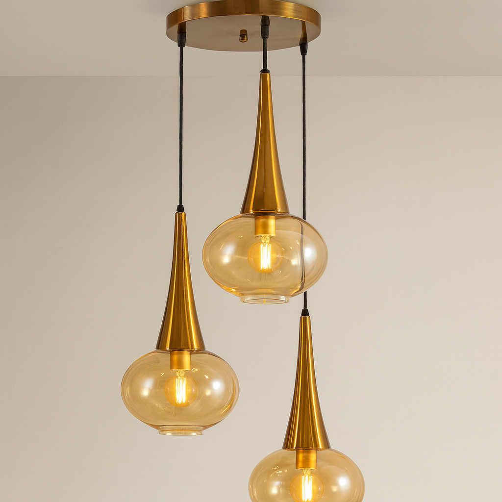 Modern pendant light with gold fixtures and glass shades on a neutral background
