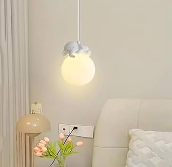 Light fixture hanging above a bed with a neutral background