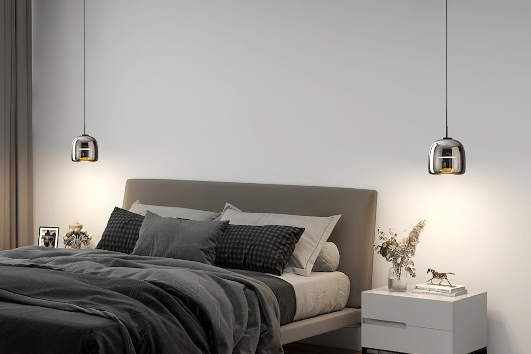 Modern bedroom with a bed, nightstands, and pendant lights.