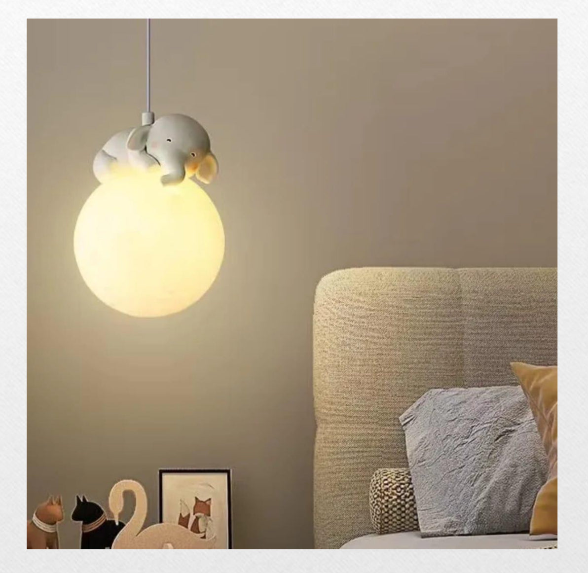 Light fixture hanging above a bed in a bedroom setting