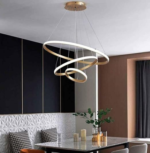Modern pendant light fixture in a dining room setting with a table and decorative elements.