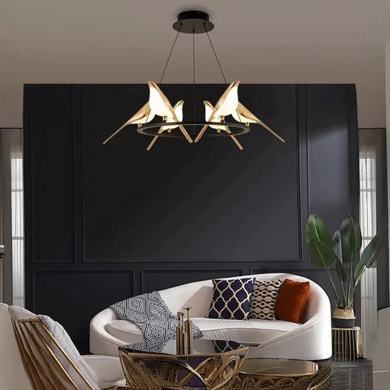 Modern living room with a stylish chandelier, white sofa, and decorative pillows.