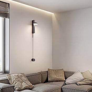 Modern living room with a gray sofa and wall-mounted light fixture.