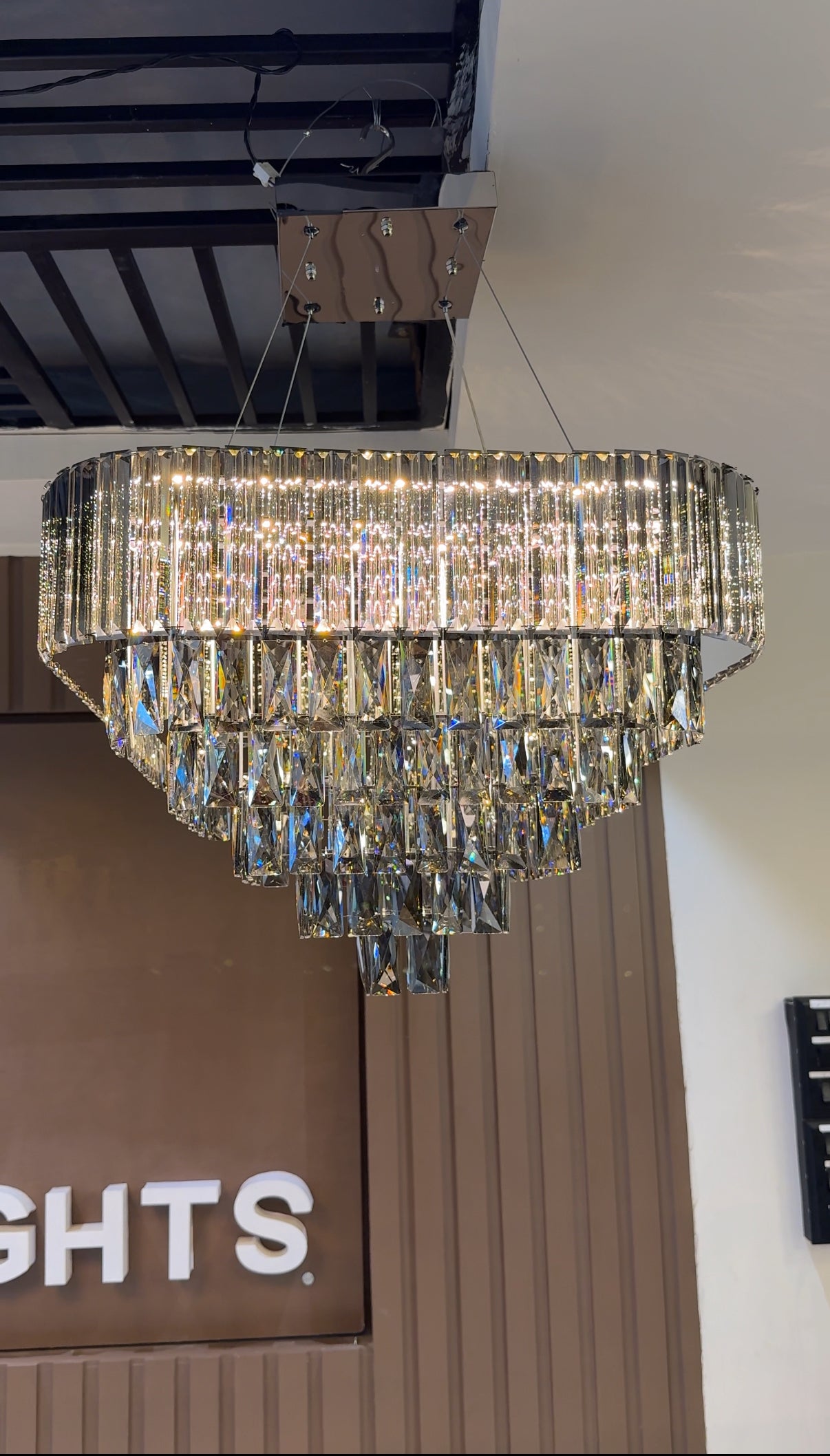 Crystal chandelier hanging from a ceiling with a blurred background
