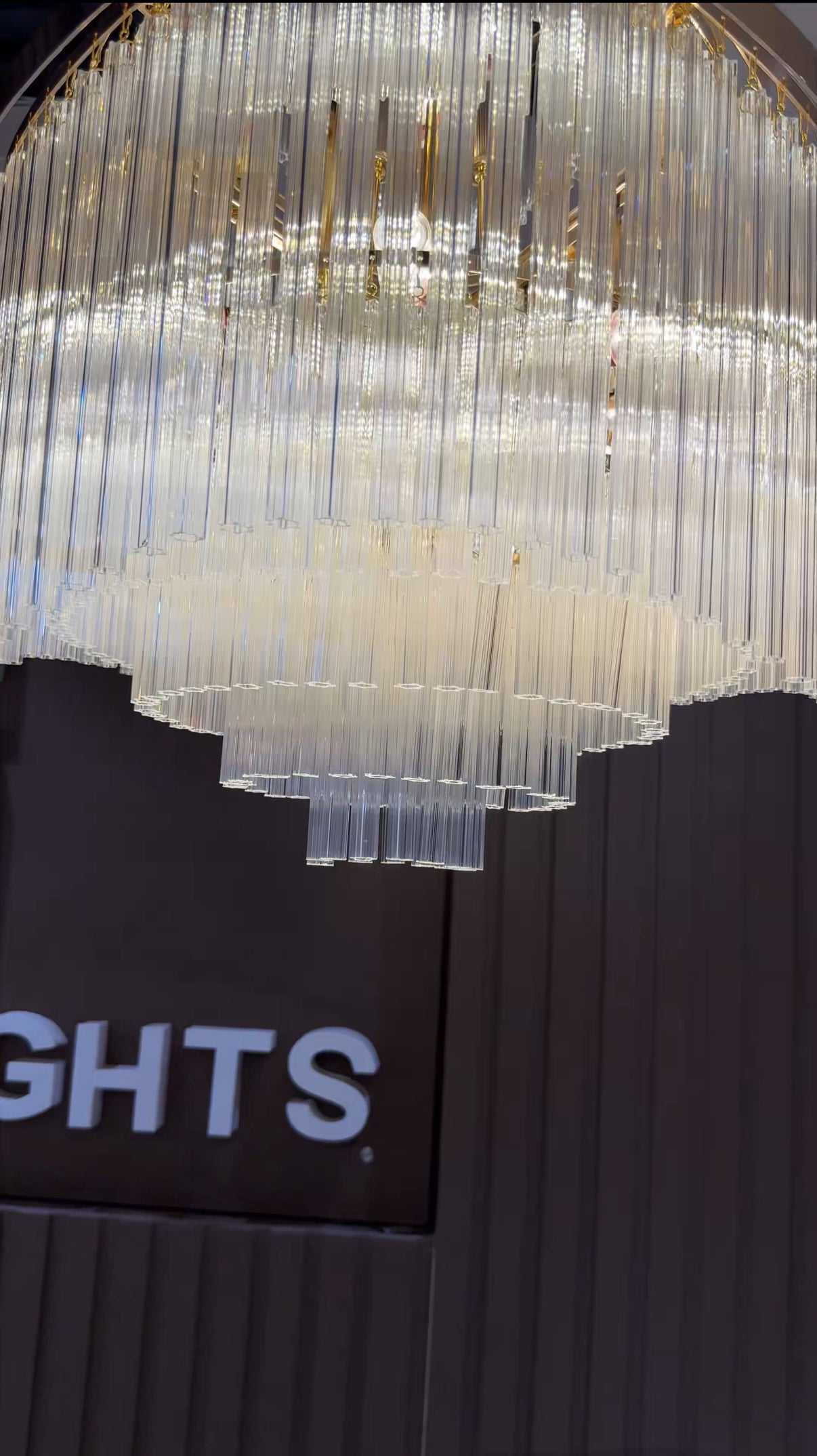 Chandelier with 'LIGHTS' branding in the background