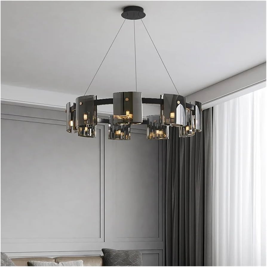 Modern chandelier hanging in a room with neutral walls and a window.