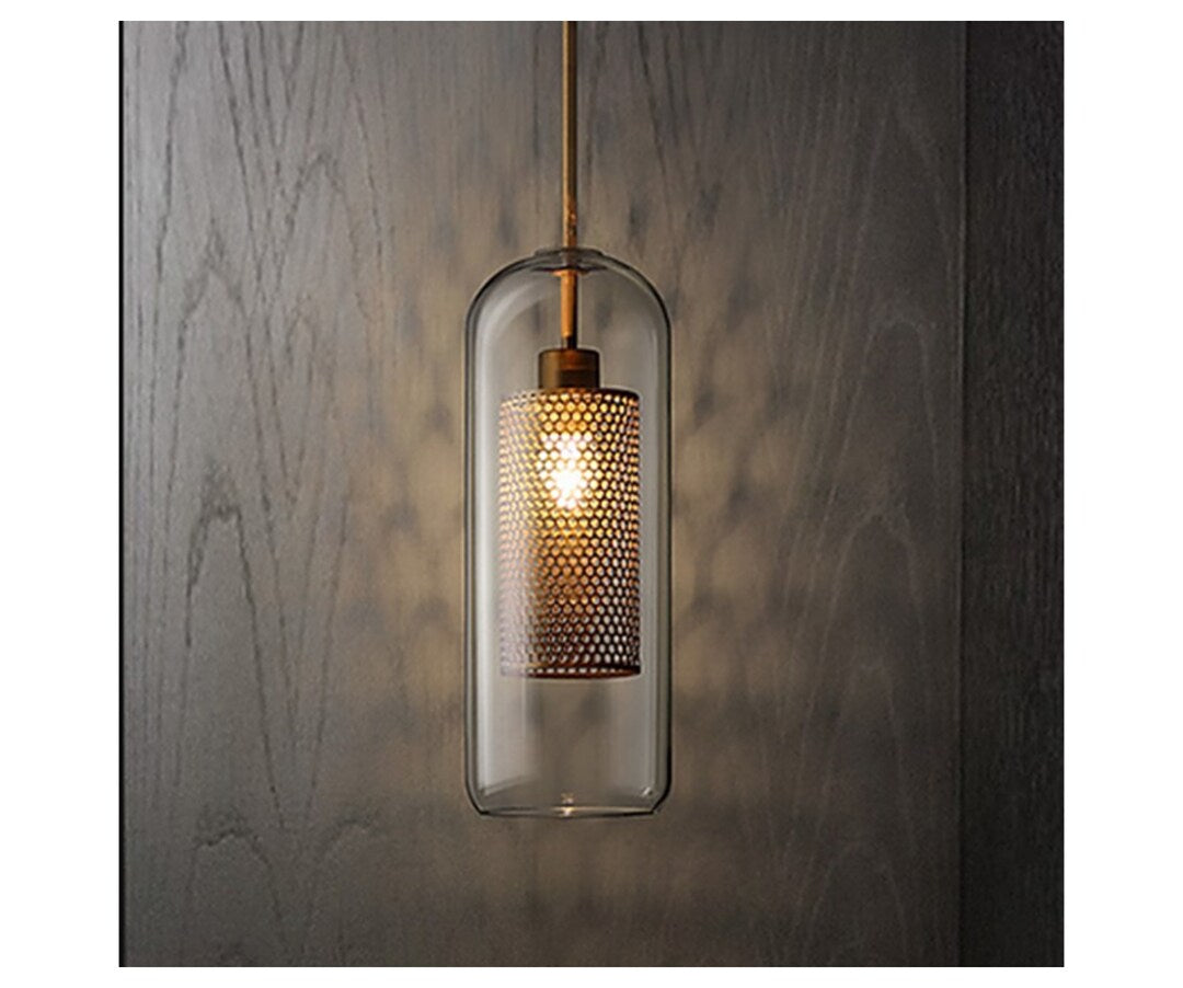 Pendant light with textured glass shade against a wooden wall