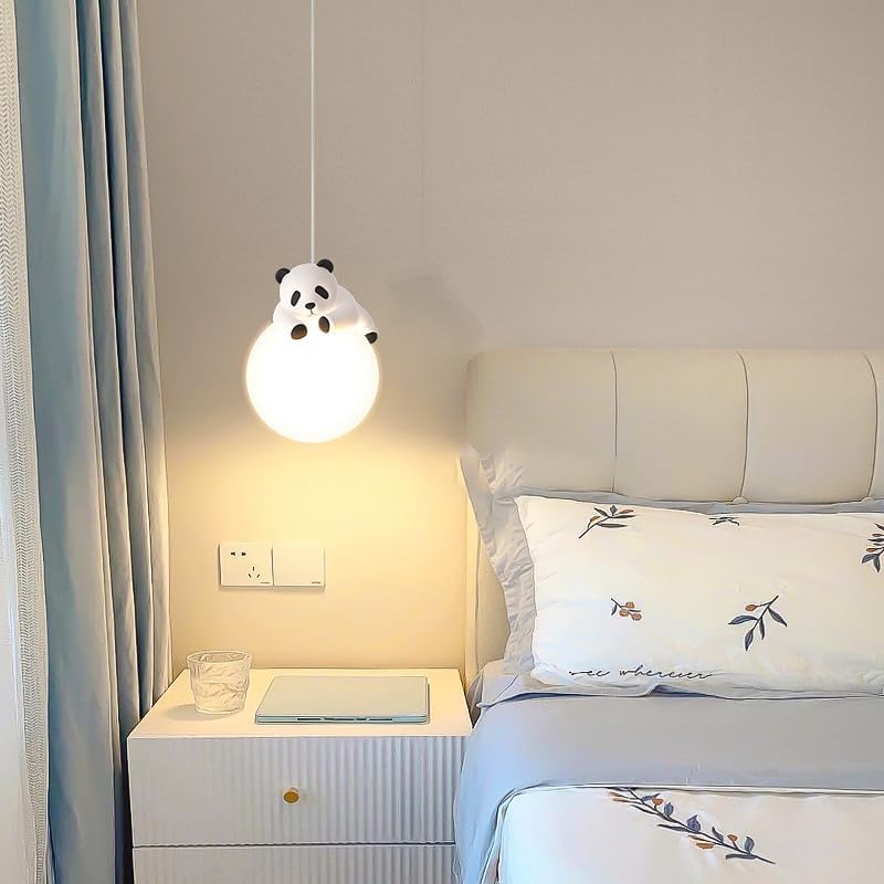 Panda-shaped pendant light above a bed in a bedroom setting