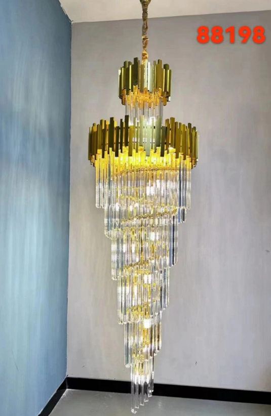 A gold cascade icicle crystal chandelier hanging from the ceiling, with a complex structure of icicles and a metallic frame.
