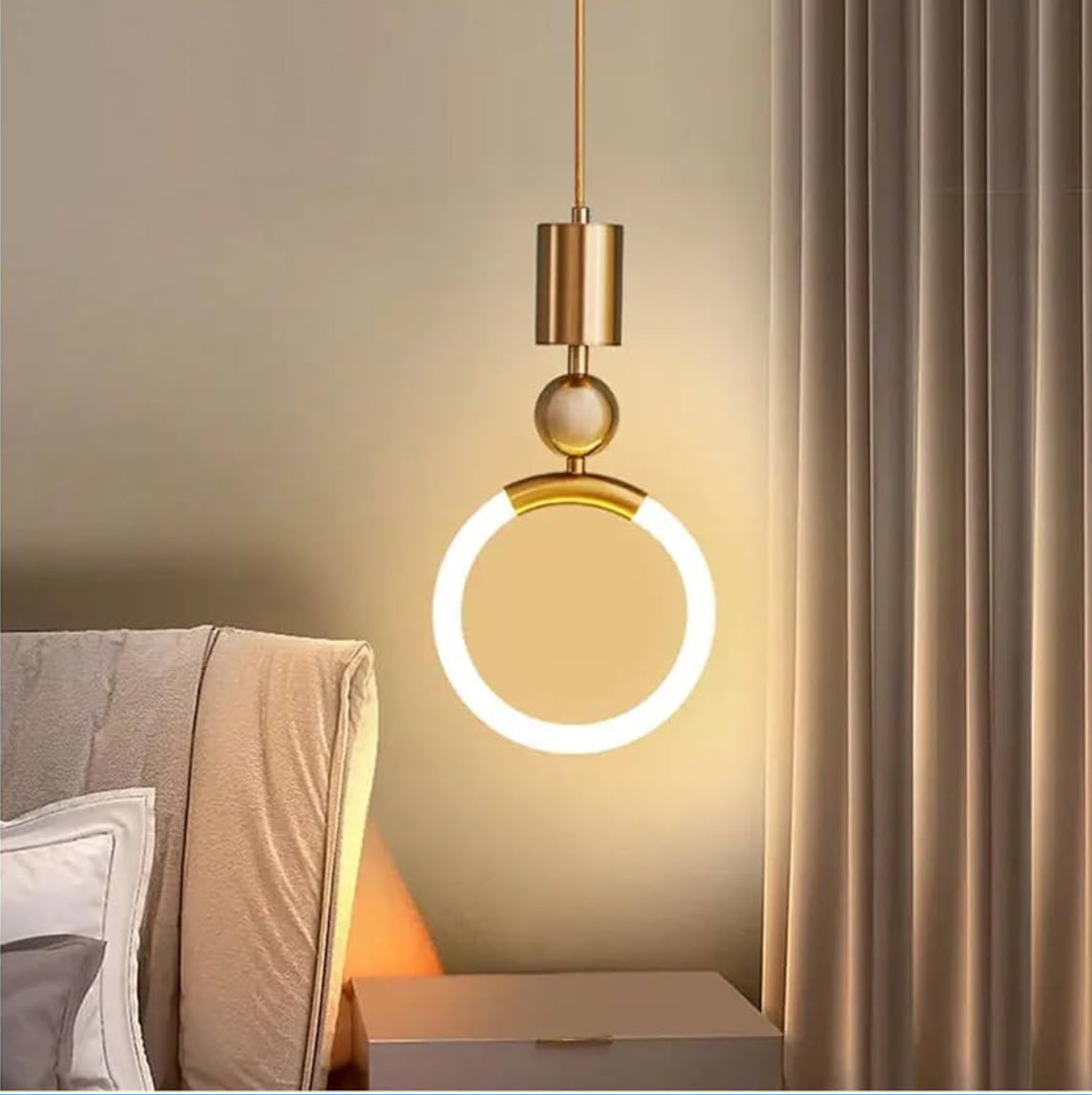 Modern pendant light fixture in a bedroom setting with neutral colors.