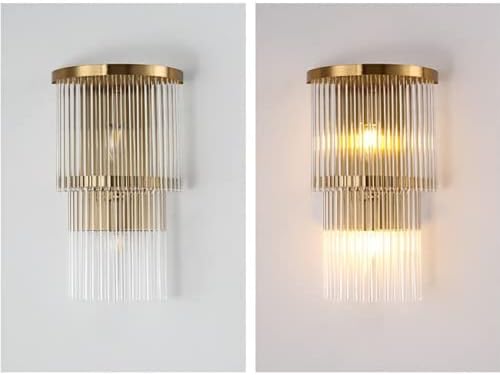 Two gold wall sconces with glass accents on a white background