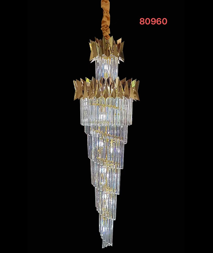 A golden wedge crystal chandelier with a metal structure and multiple hanging crystal pieces.