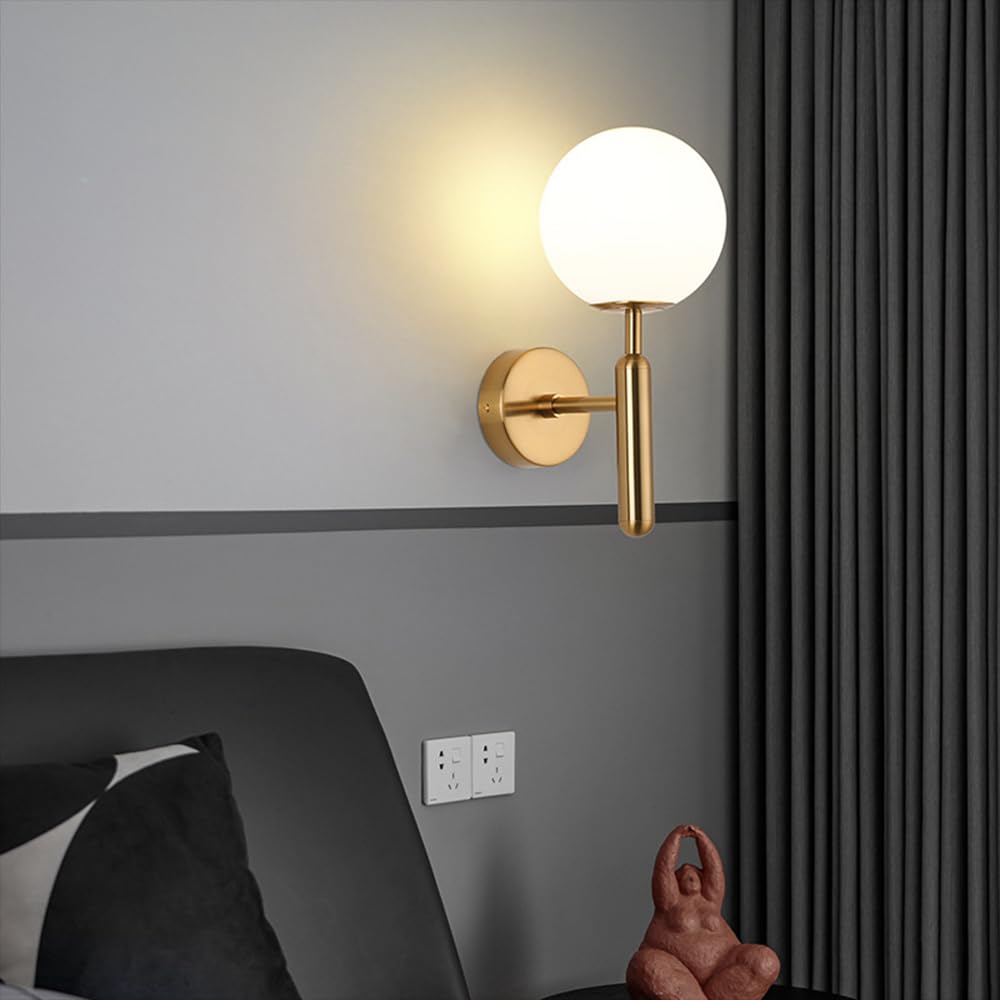 Wall-mounted lamp with a round glass shade in a room setting.