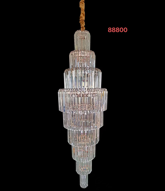A golden-colored, crystal chandelier with a geometric pattern and a hanging structure.
