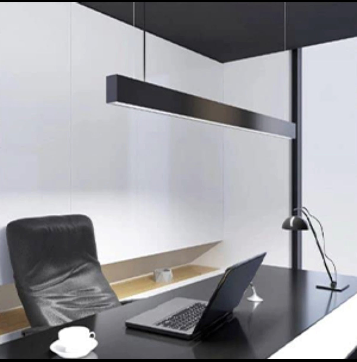 Modern office desk setup with a laptop, chair, and lamp in a minimalistic office.