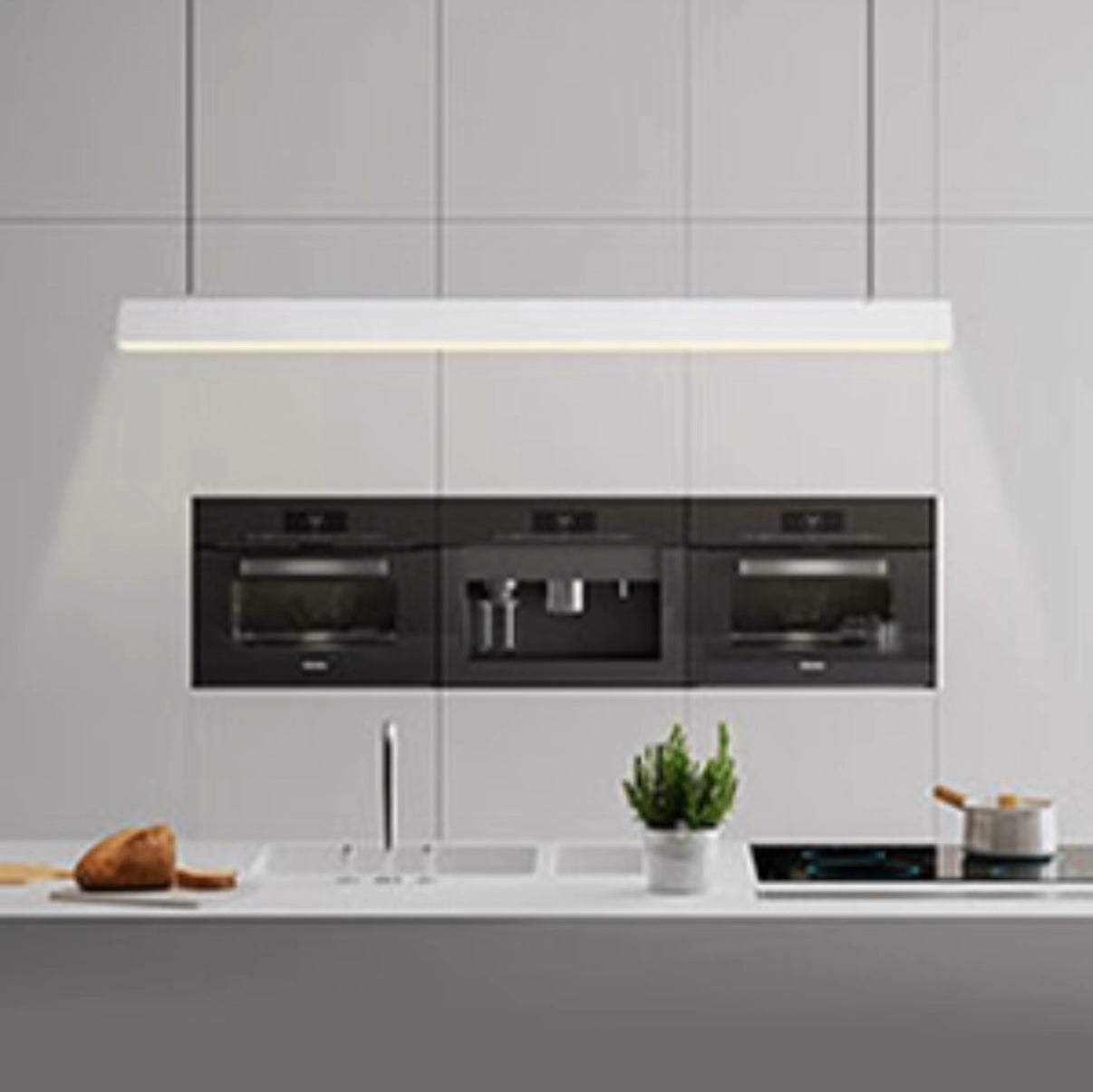 Modern kitchen with built-in appliances and a white countertop.