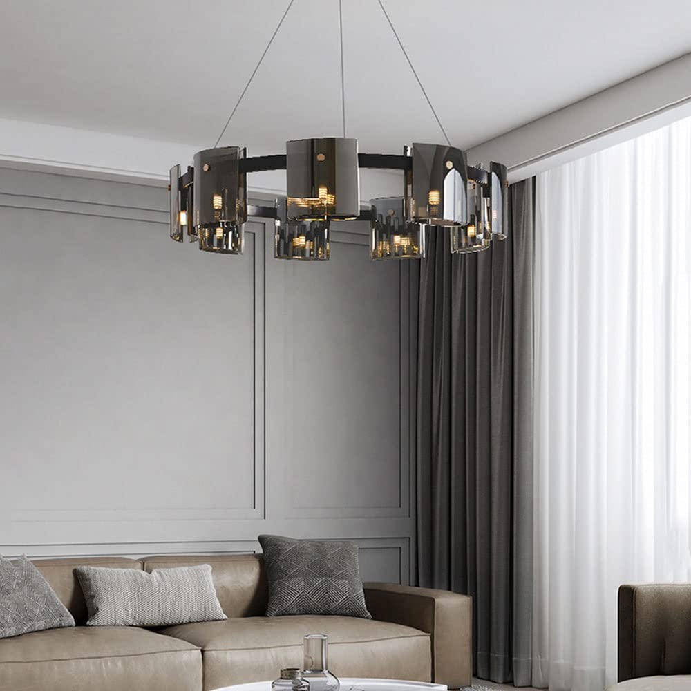 Modern chandelier hanging above a living room with a sofa and window.