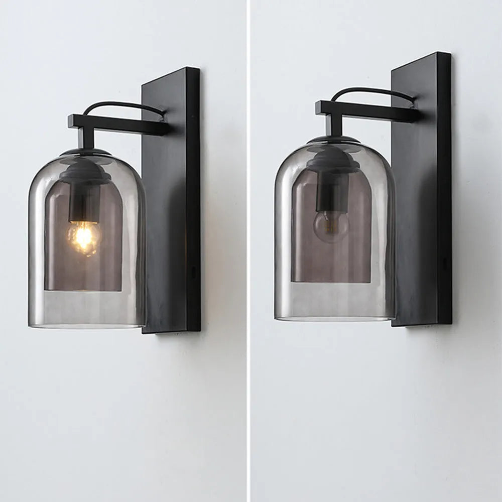 Pair of wall sconces with smoked glass shades on a white background