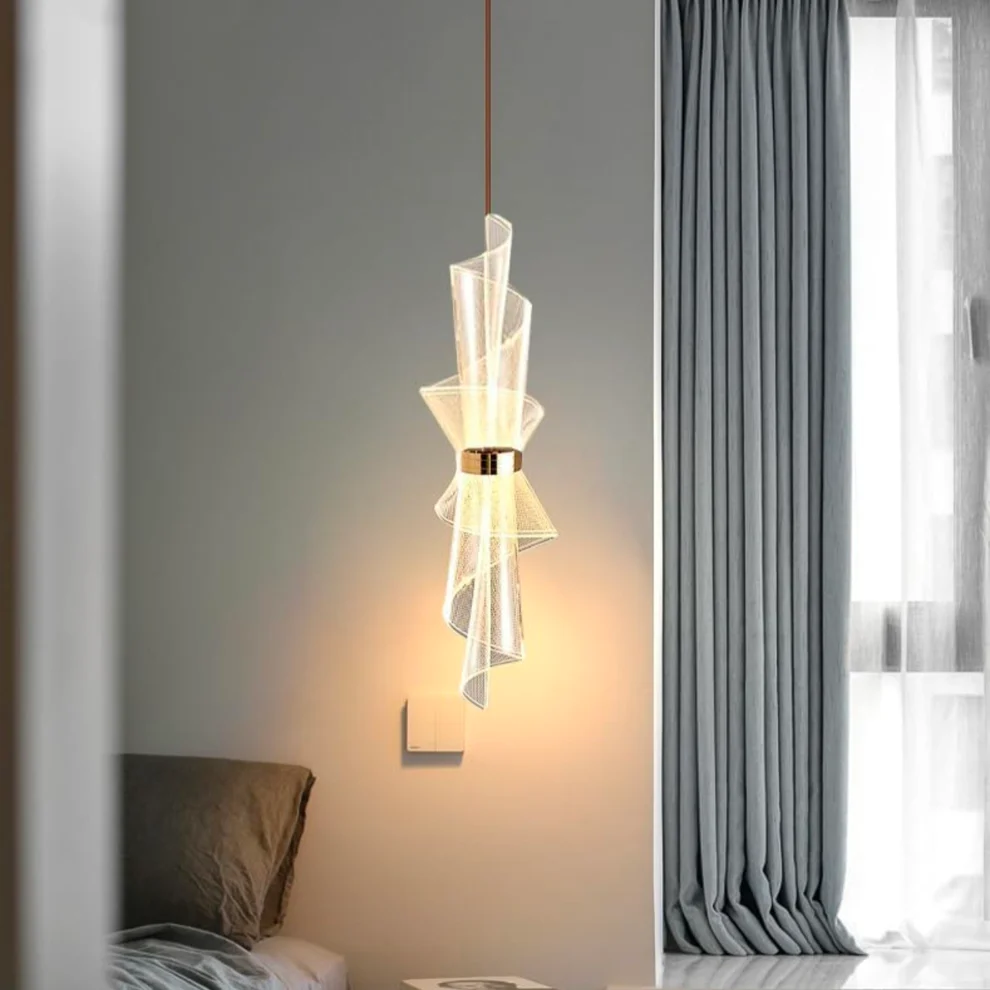 Modern pendant light fixture in a bedroom setting with gray curtains.