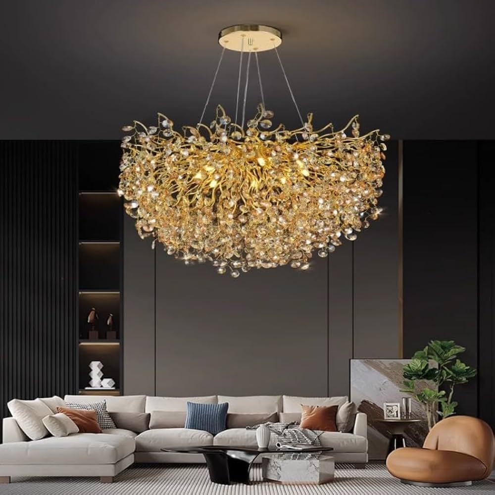 Luxurious chandelier hanging in a modern living room with a gray sofa and decorative pillows.