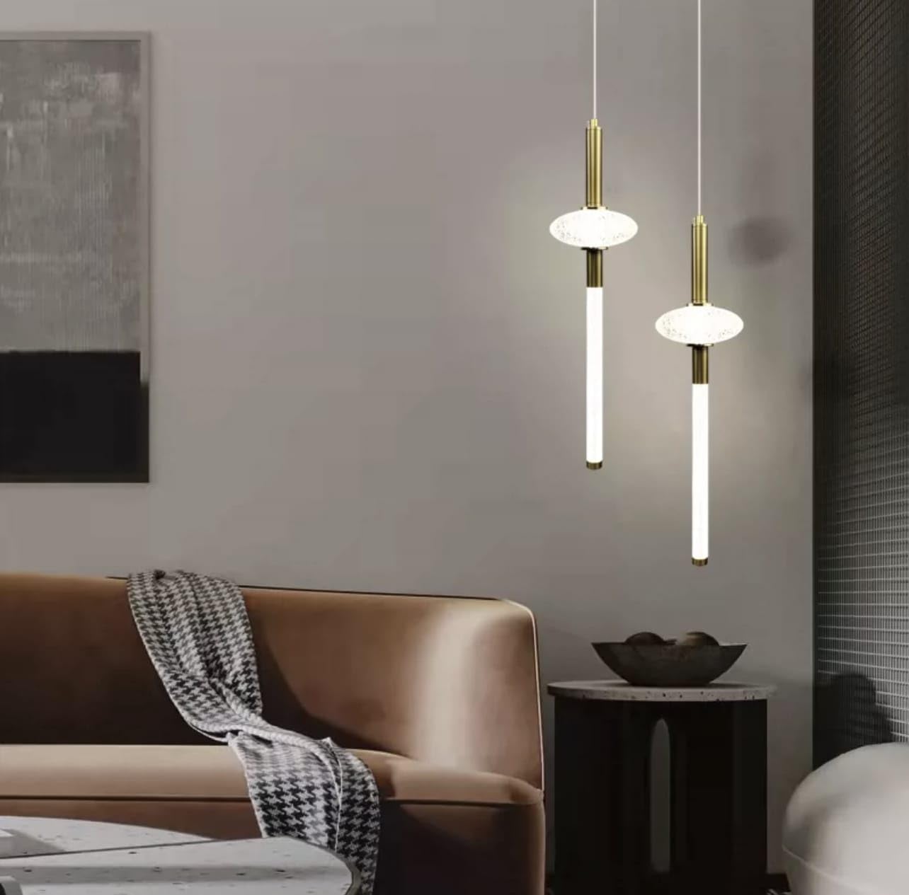 Modern living room with pendant lights, sofa, and decorative items.