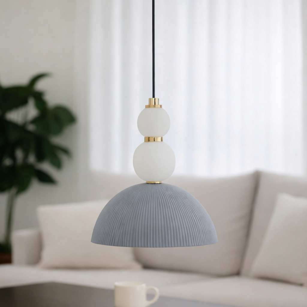 Modern pendant light with a gray shade and white globe in a living room setting.