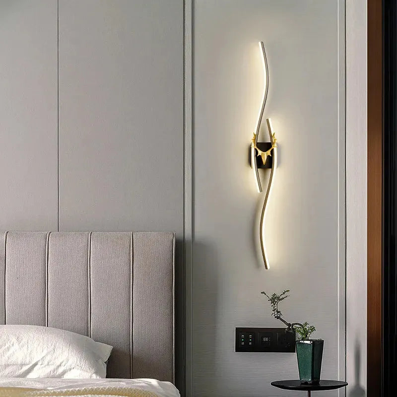 Modern wall lamp on a gray wall above a bed