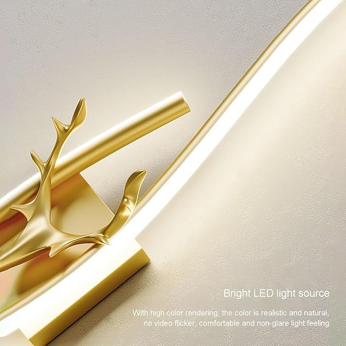 Gold wall sconce with antler design on a light background