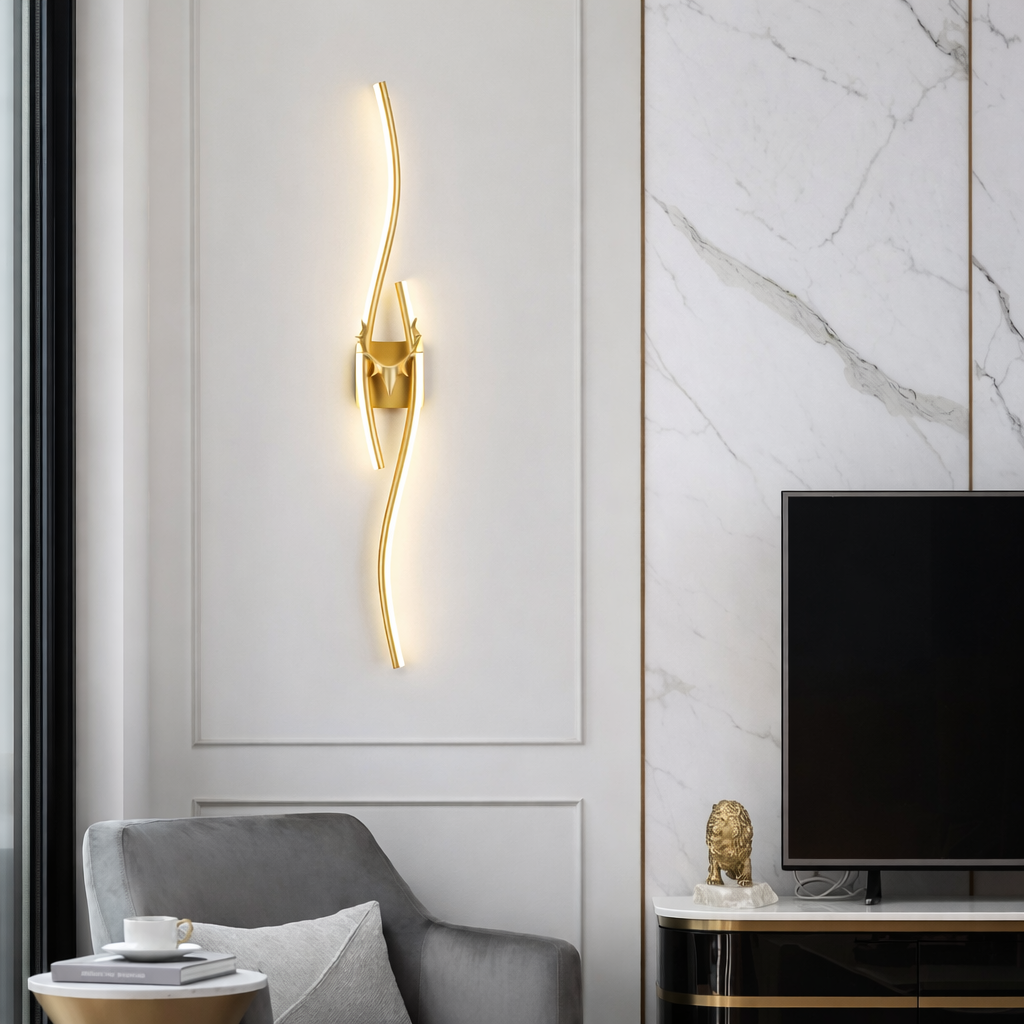 Modern living room with gold wall sconce, gray armchair, and marble wall.