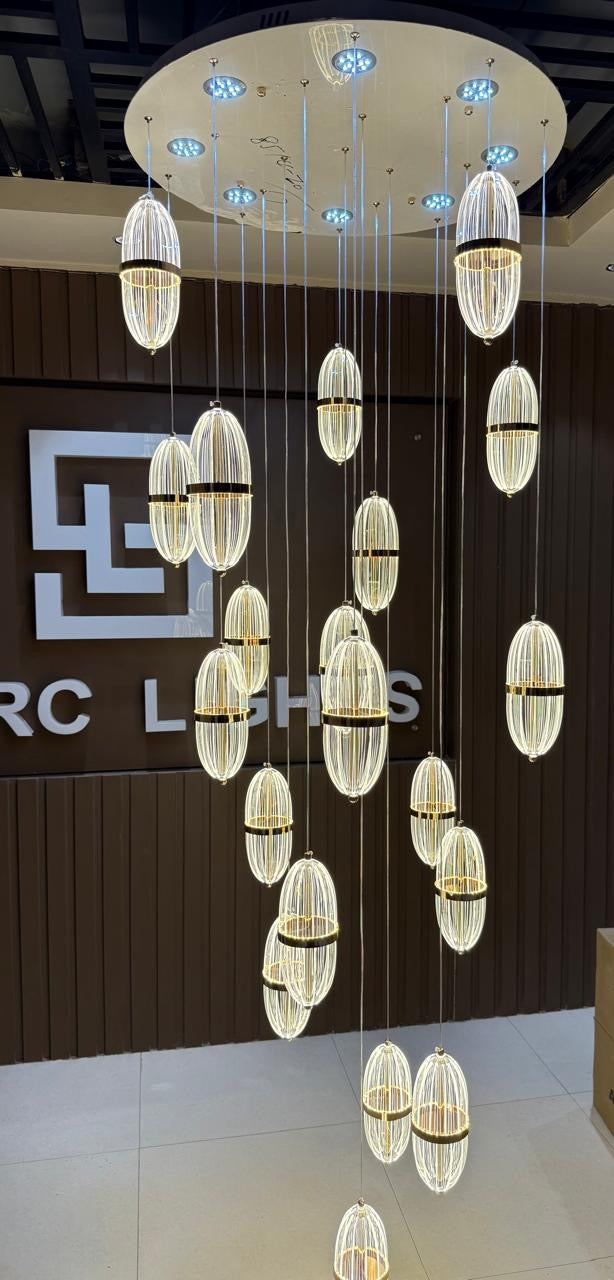 Chandelier with multiple lights hanging from the ceiling in a showroom setting.