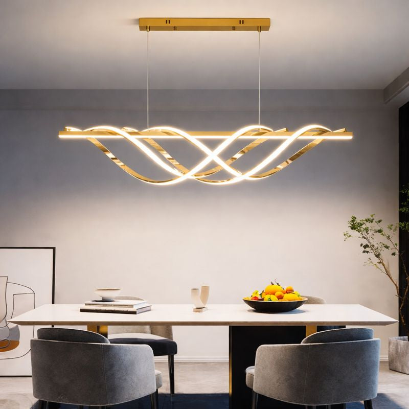 Modern dining room with a gold pendant light fixture above a table.