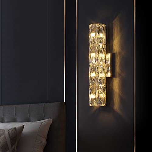 Decorative wall sconce on a dark wall with a bed in the background