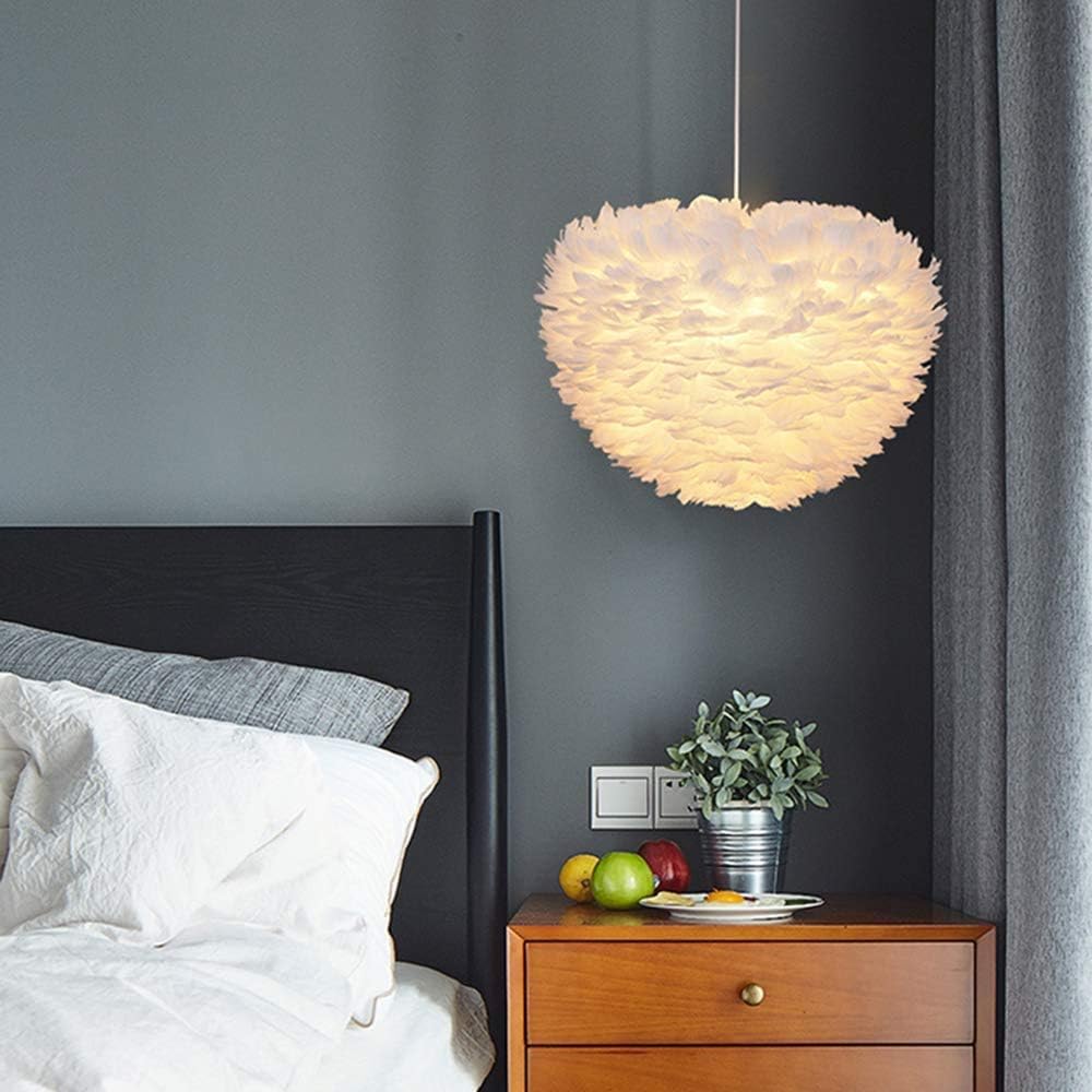 Modern bedroom with a feather pendant light, bed, and nightstand.